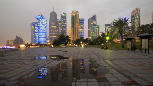 Illuminated cityscape against sky at night