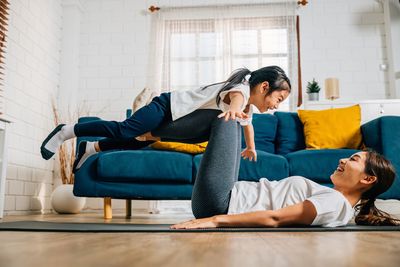 Female friends using digital tablet while sitting at home