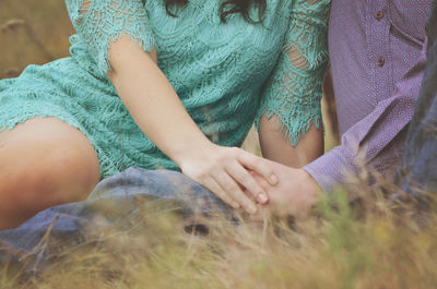 Close-up of couple holding hands