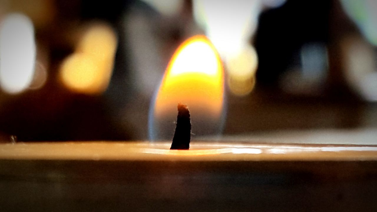 illuminated, night, focus on foreground, indoors, glowing, selective focus, orange color, lighting equipment, silhouette, light - natural phenomenon, flame, close-up, burning, defocused, lit, candle, dark, no people, light, reflection