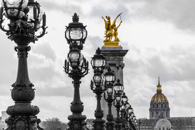 Sculpture of building against cloudy sky