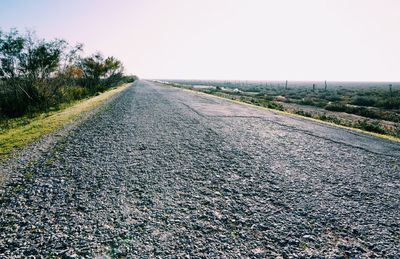 Surface level of road against clear sky