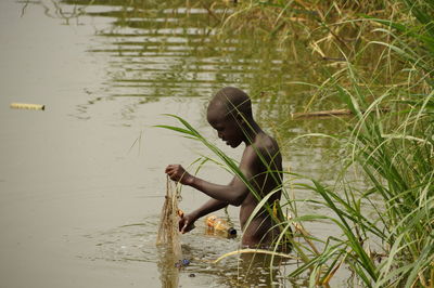 Side view of young woman in lake