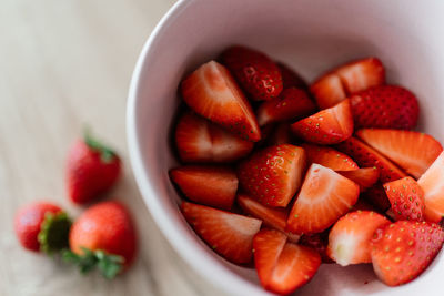 High angle view of chopped fruits in bowl on table