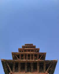 Low angle view of building against clear blue sky