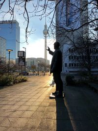 Man walking on sidewalk in city