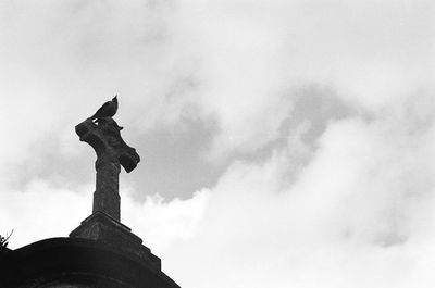 Low angle view of statue against sky