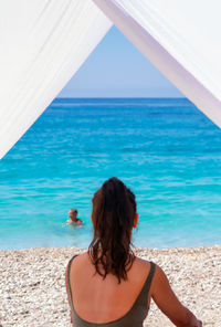 Rear view of woman looking at sea