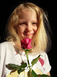 Close-up of woman holding flower