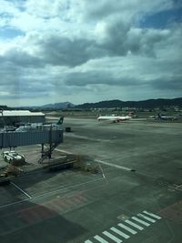 Airplane on road against sky