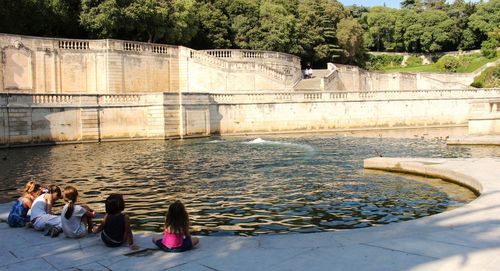 People sitting on riverbank