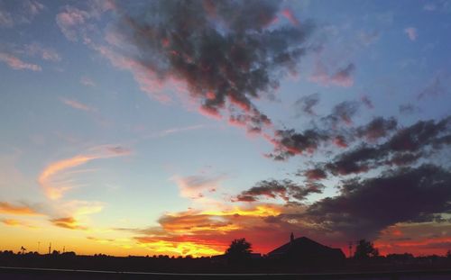 Silhouette buildings against sky during sunset