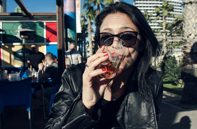 Portrait of mid adult man drinking glass