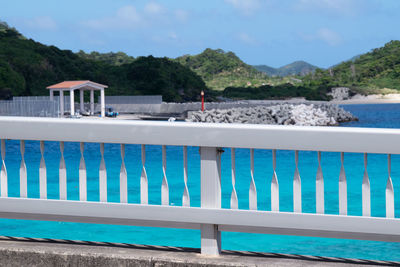 Swimming pool by sea against sky