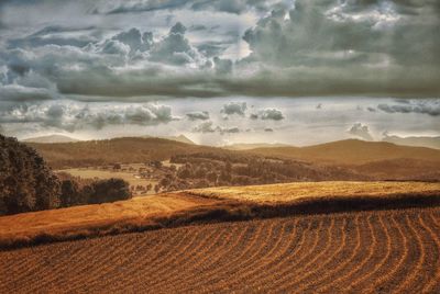 Scenic view of landscape against cloudy sky