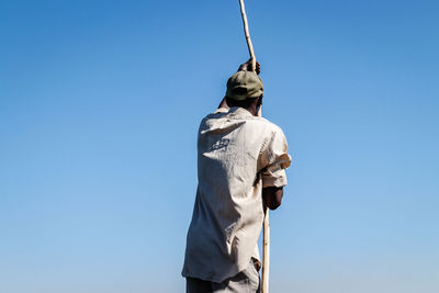 Low angle view of statue against blue sky