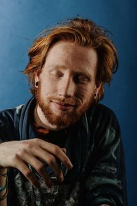 Portrait of smiling man against blue background