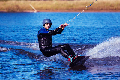 Portrait of young man wakeboarding in sea