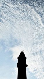 Low angle view of silhouette statue against sky