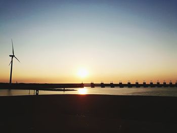 Scenic view of river against orange sky