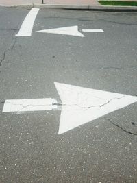 Close-up of arrow symbol on road
