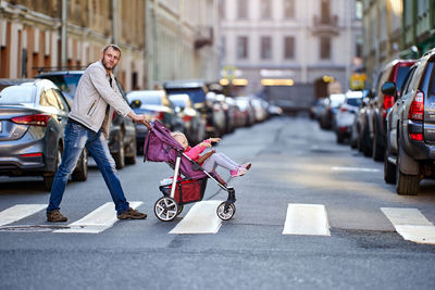 Man with daughter walking in city