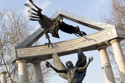 Low angle view of statue against sky