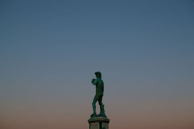 Low angle view of statue against blue sky