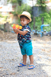 Lovely thai boy aged 1 year 11 months playing water gun songkran festival in thailand.