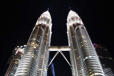 Low angle view of illuminated building against sky at night