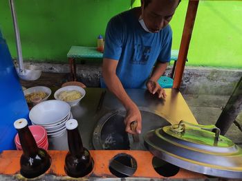 Rear view of man preparing food