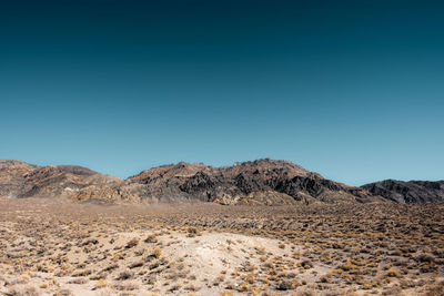 Scenic view of arid landscape against clear sky