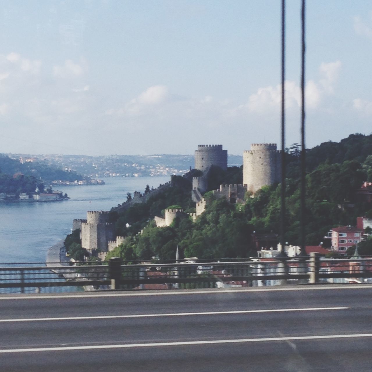 architecture, built structure, sky, building exterior, city, road, transportation, water, river, sea, cityscape, bridge - man made structure, railing, street, connection, cloud - sky, road marking, day, cloud, outdoors