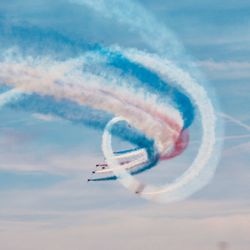 Low angle view of airplane flying against sky