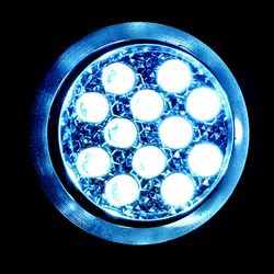 Low angle view of illuminated light bulb against black background