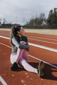 Woman exercising at running track