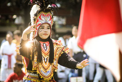 Midsection of woman dancing in traditional clothing during festival