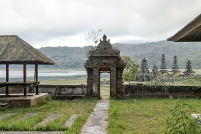 View of temple building against cloudy sky