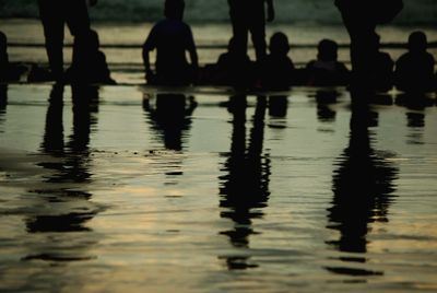 Low section of silhouette people in water