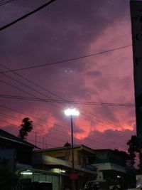 Low angle view of buildings against sky at dusk