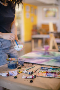 Midsection of woman on table at cafe