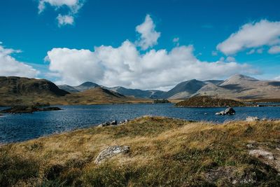 Scenic view of lake and mountains against sky