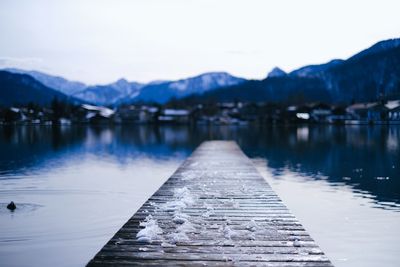 Scenic view of lake against sky during winter