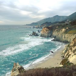 Scenic view of sea against cloudy sky