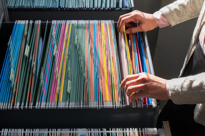 Close-up of hand holding multi colored piano