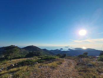 Scenic view of mountains against blue sky