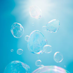 Close-up of bubbles against blue background