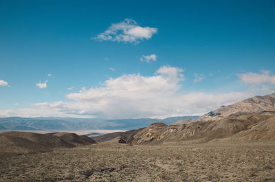 Scenic view of mountains against blue sky