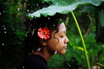 Close-up portrait of teenage girl with plants in water