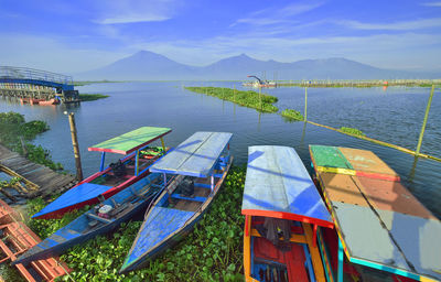 High angle view of boats moored in lake against sky